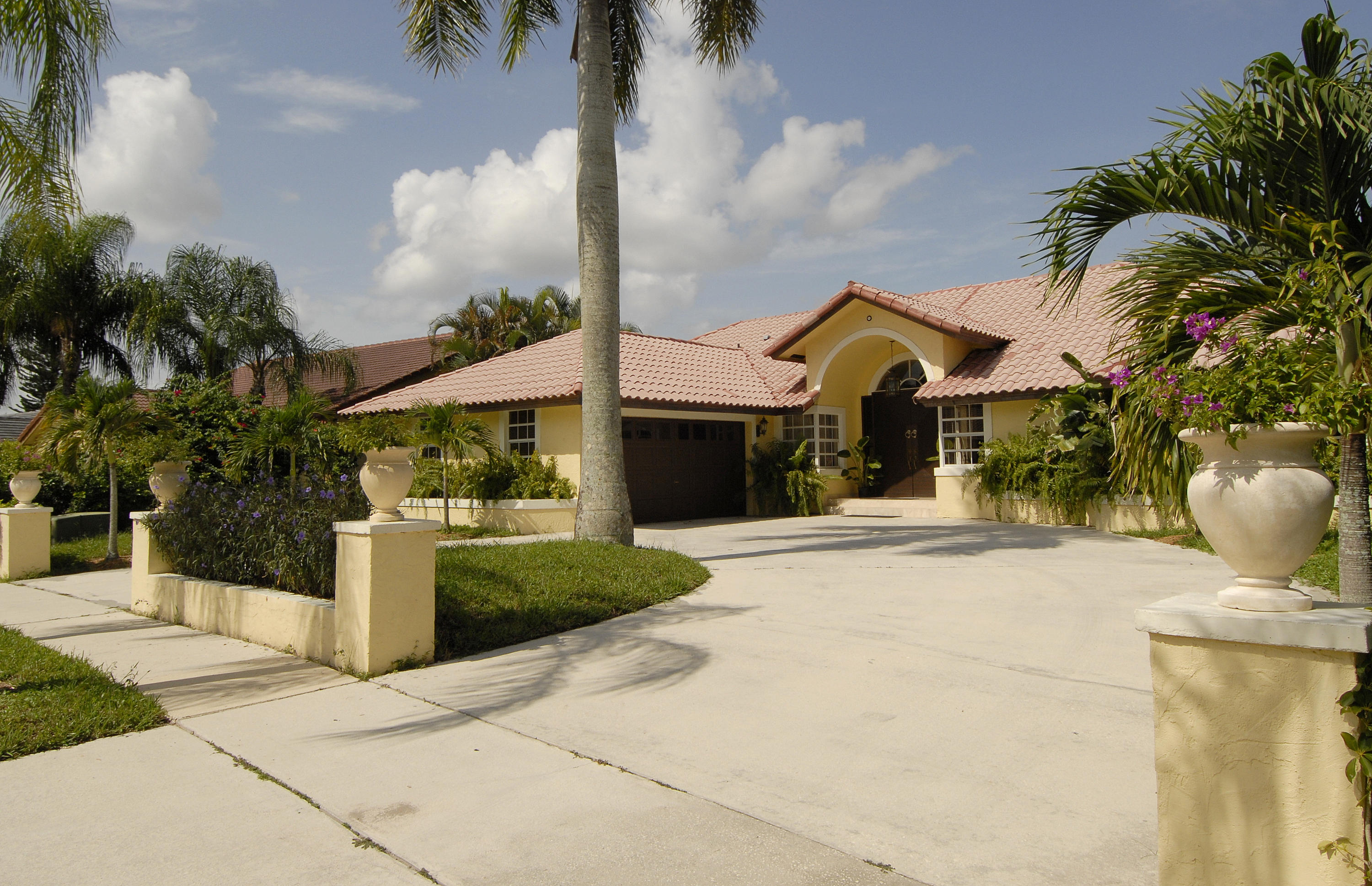21347 Chinaberry Drive Boca Raton, FL 33428 - Photo 2 of 35 a front view of a house with a garden and patio