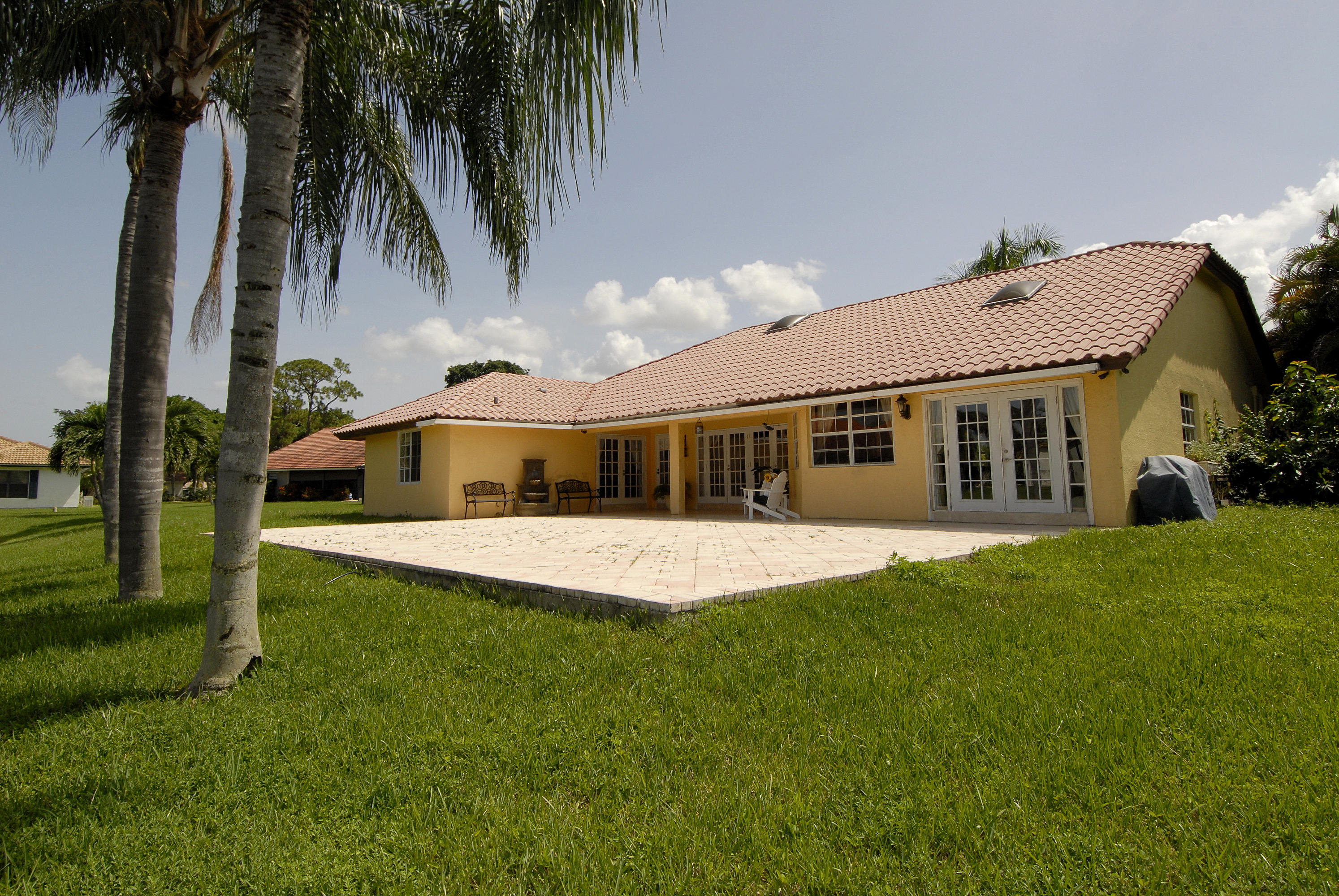 21347 Chinaberry Drive Boca Raton, FL 33428 - Photo 3 of 35 a front view of a house with a garden and yard