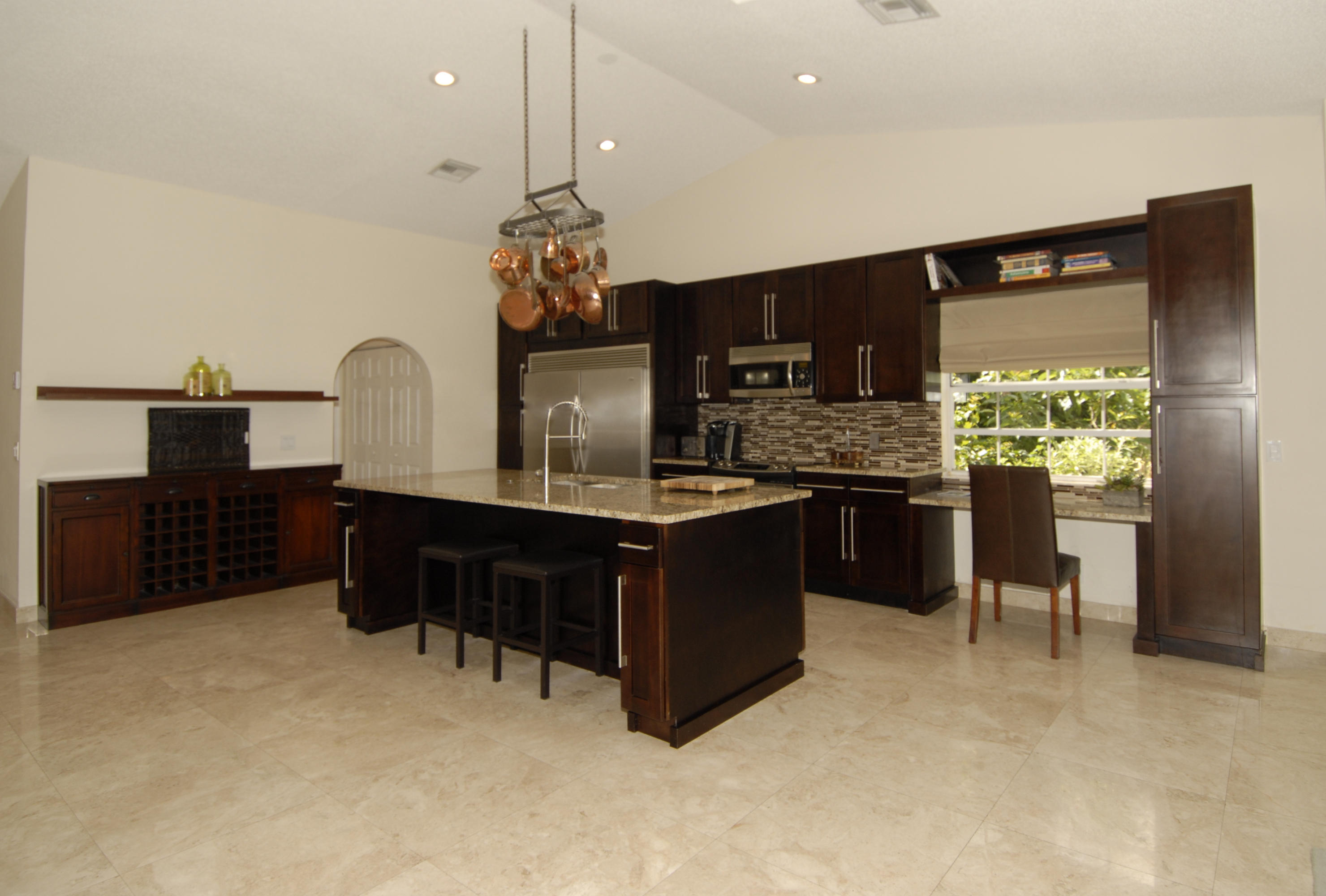 21347 Chinaberry Drive Boca Raton, FL 33428 - Photo 10 of 35 a kitchen with stainless steel appliances kitchen island granite countertop a stove and cabinets