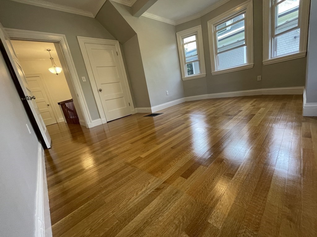 116 Dickerman Road Newton, MA 02461 - Photo 12 of 40 a view of an empty room with wooden floor and a window