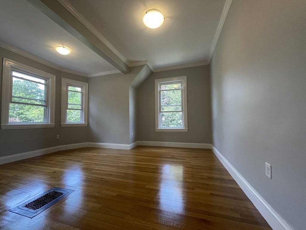 116 Dickerman Road Newton, MA 02461 - Photo 13 of 40 an empty room with wooden floor and windows