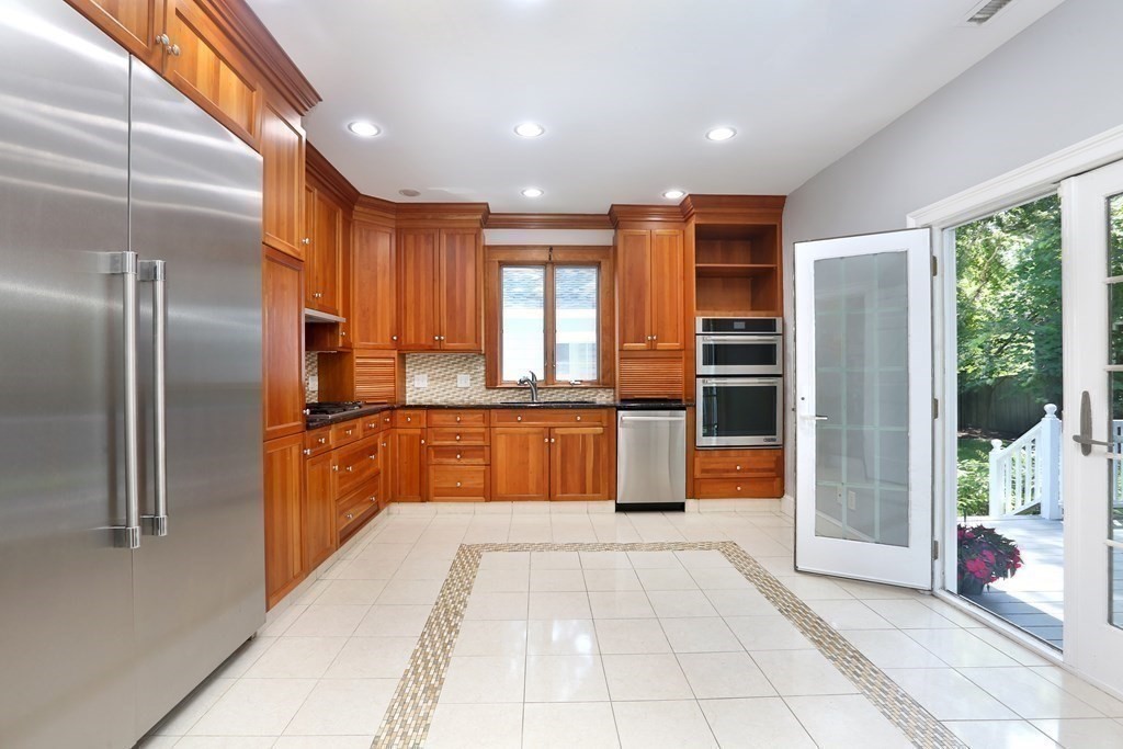 116 Dickerman Road Newton, MA 02461 - Photo 6 of 40 a large kitchen with stainless steel appliances kitchen island granite countertop a refrigerator and a sink