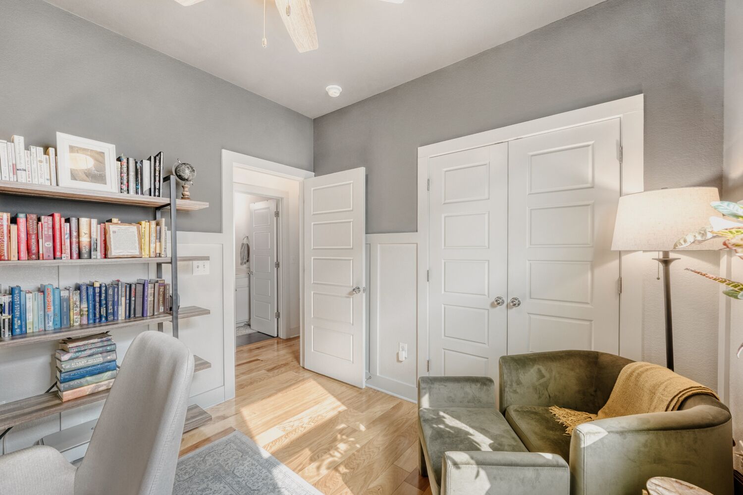 2000 Hermia Street Austin, TX 78741 - Photo 18 of 28 Office area featuring light wood-style flooring, wainscoting, a ceiling fan, and a decorative wall