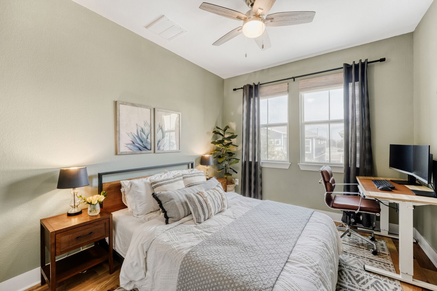 2000 Hermia Street Austin, TX 78741 - Photo 19 of 28 Bedroom with wood finished floors, a ceiling fan, and a desk