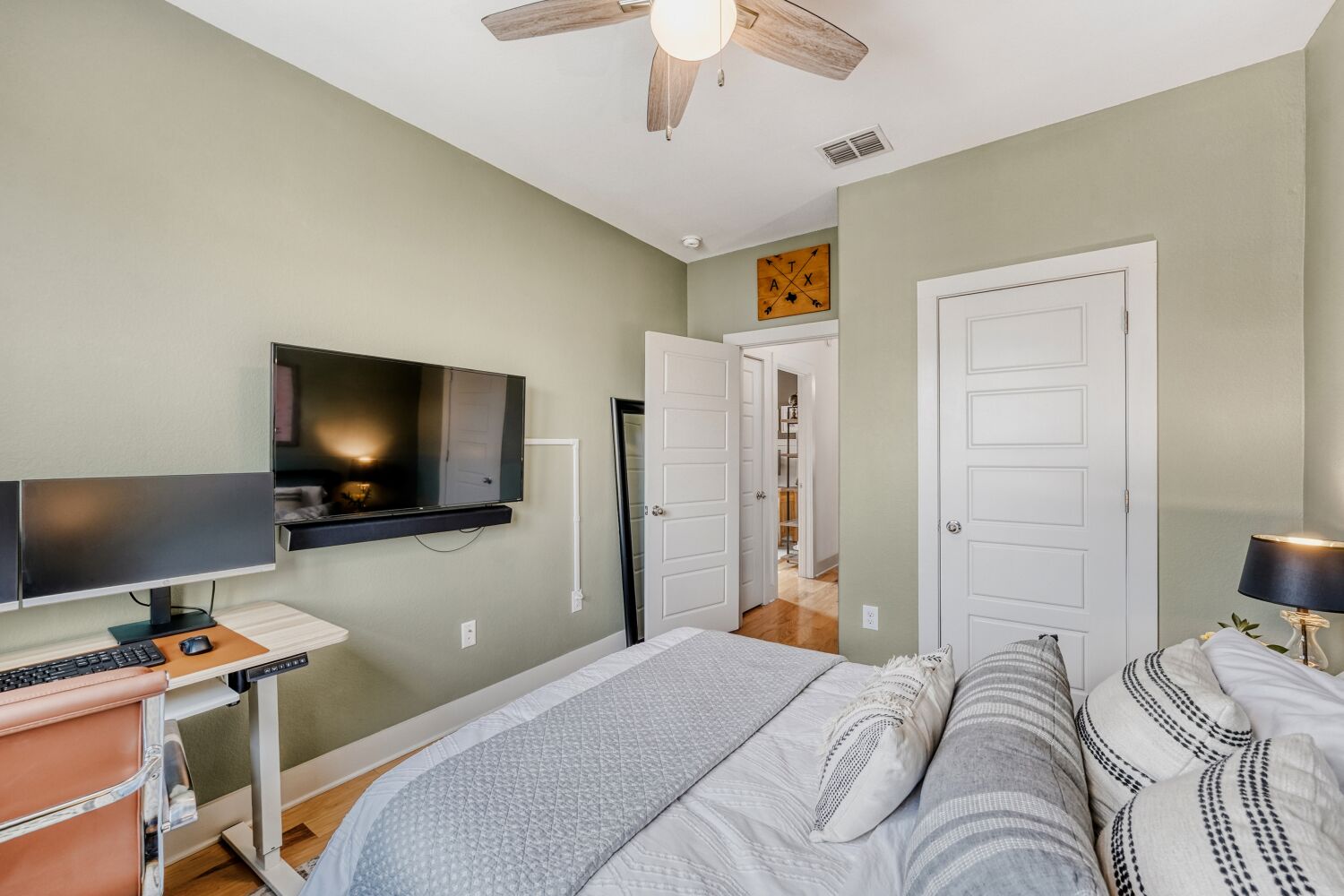 2000 Hermia Street Austin, TX 78741 - Photo 20 of 28 Bedroom with wood finished floors, a closet, a ceiling fan, and an office area