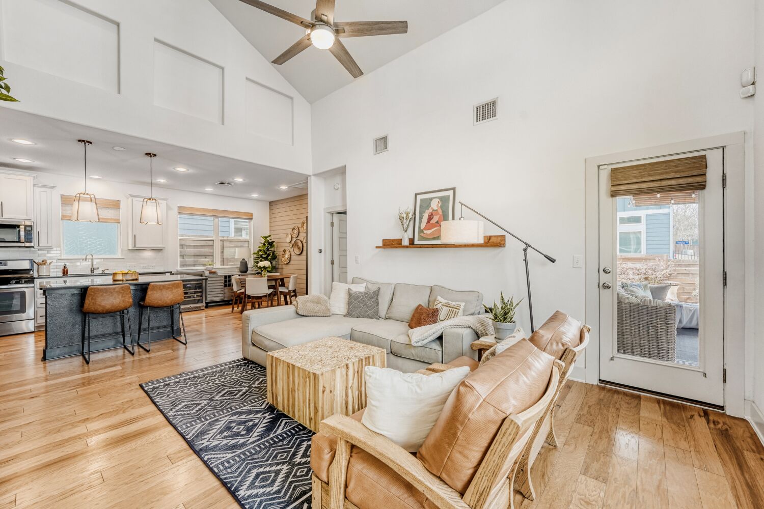 2000 Hermia Street Austin, TX 78741 - Photo 4 of 28 Living area with a ceiling fan, light wood finished floors, vaulted ceiling, and plenty of natural light