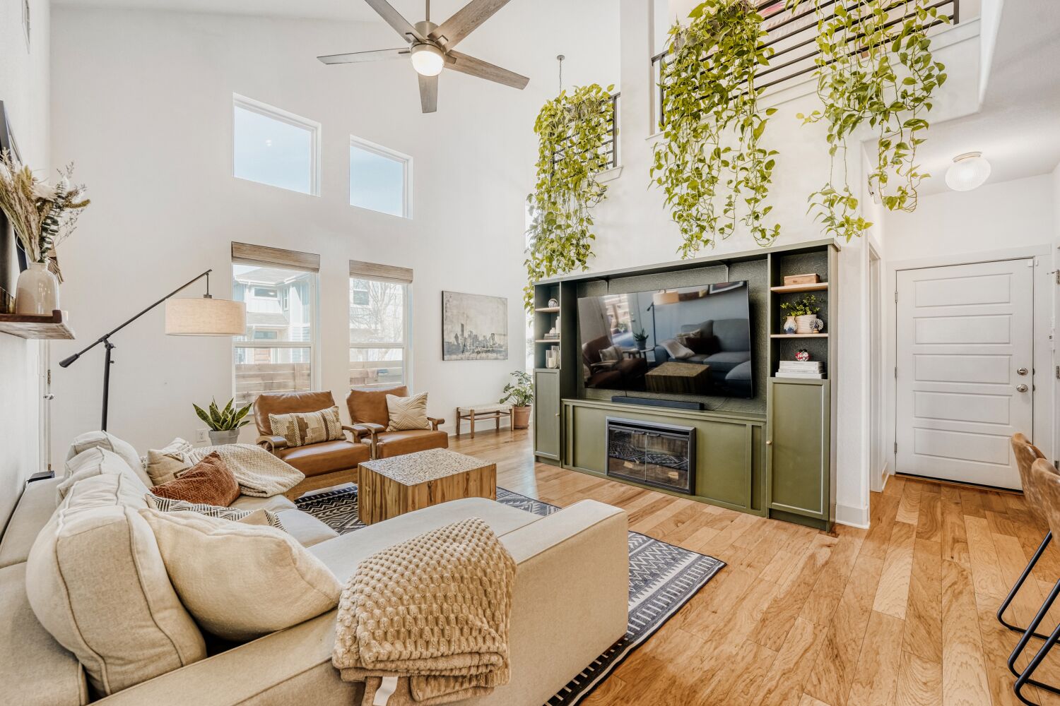 2000 Hermia Street Austin, TX 78741 - Photo 6 of 28 Living room with a high ceiling, a ceiling fan, and light wood-style floors
