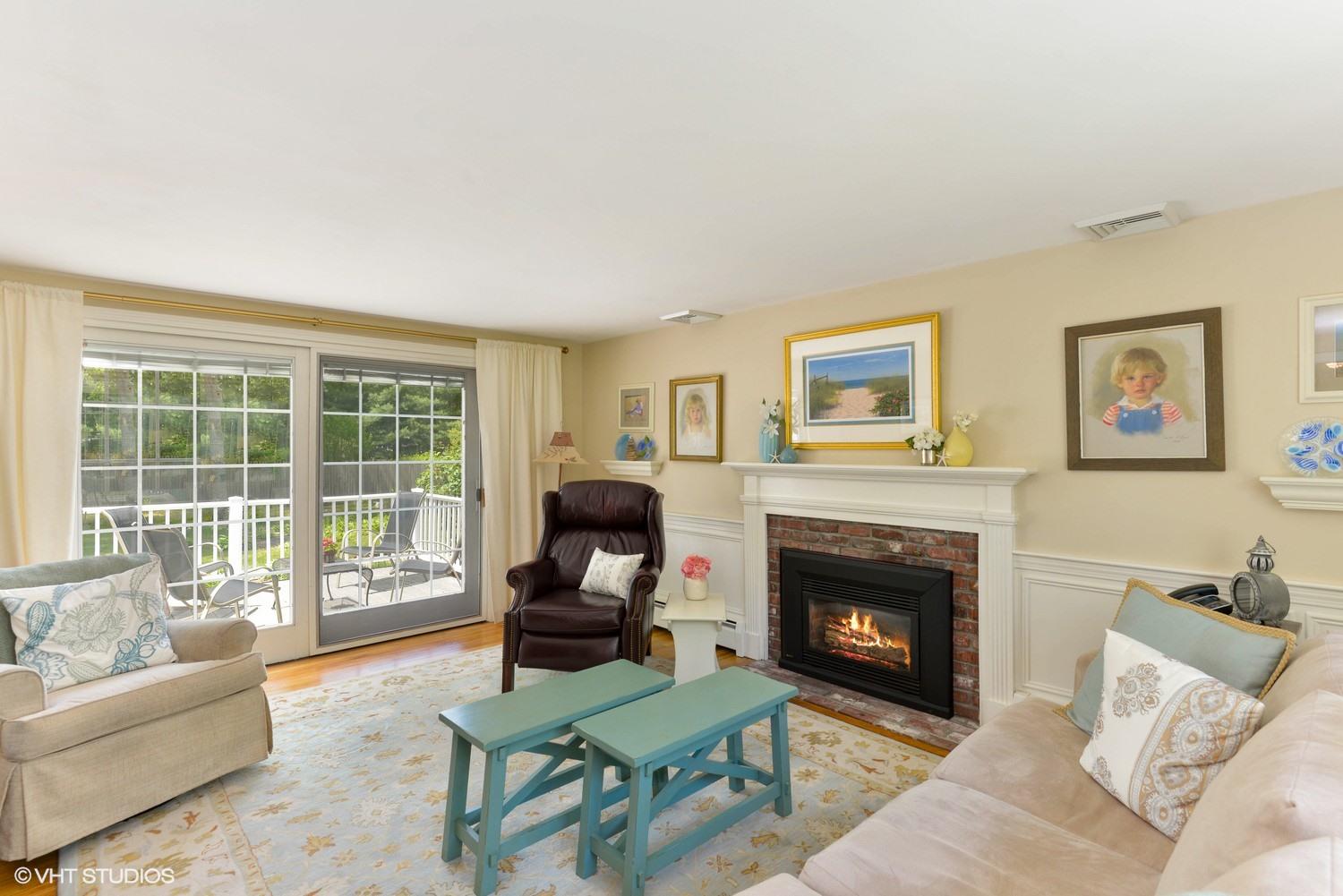 163 5 Corners Road Centerville, MA 02632 - Photo 2 of 21 a living room with furniture and a fireplace