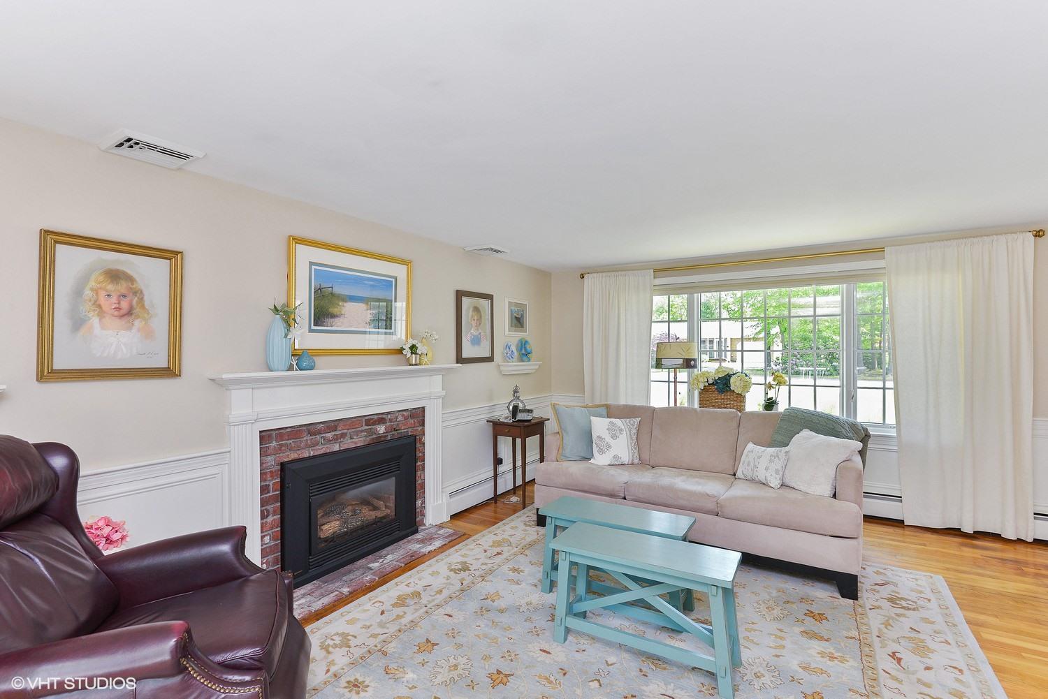 163 5 Corners Road Centerville, MA 02632 - Photo 3 of 21 a living room with furniture and a fireplace