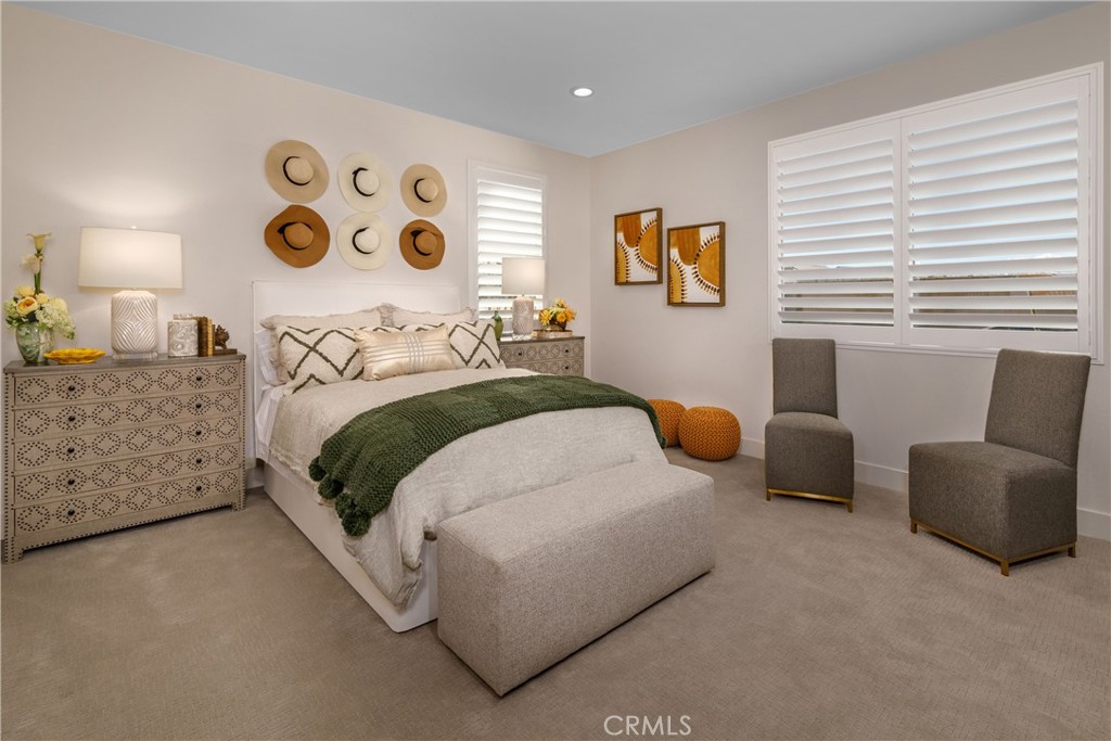 9028 Carson Avenue Hesperia, CA 92344 - Photo 7 of 11 a bedroom with a bed and a chair