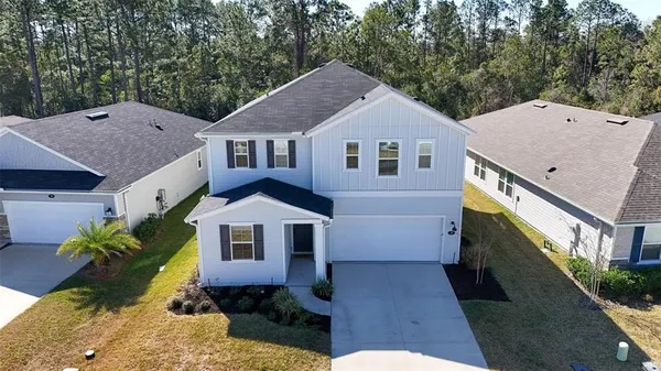 a aerial view of a house with a yard