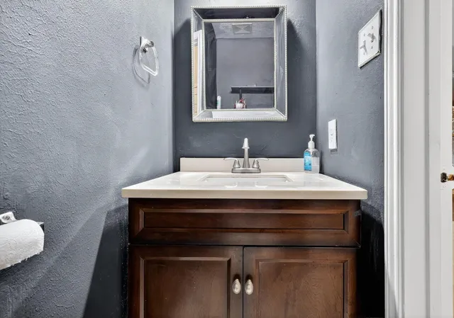 a bathroom with a sink and a mirror