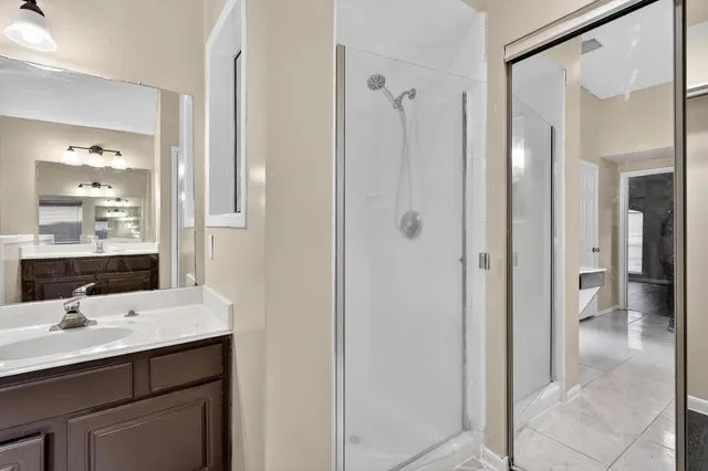 a bathroom with a sink a mirror and a shower