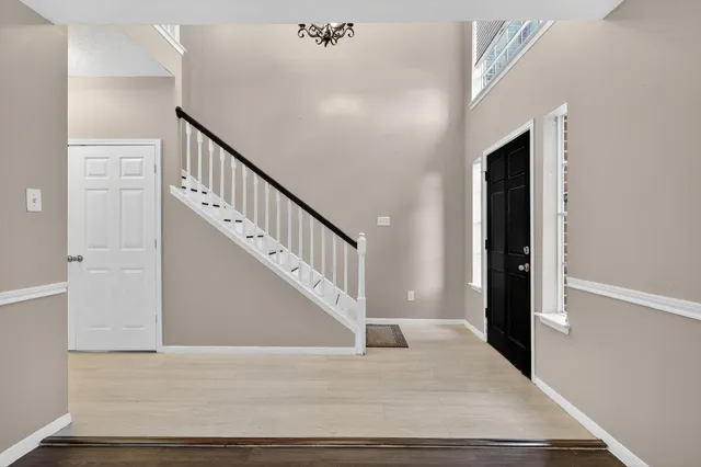 a view of entryway and hall with wooden floor