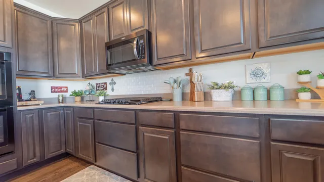 a kitchen with stainless steel appliances granite countertop wooden cabinets a sink and dishwasher