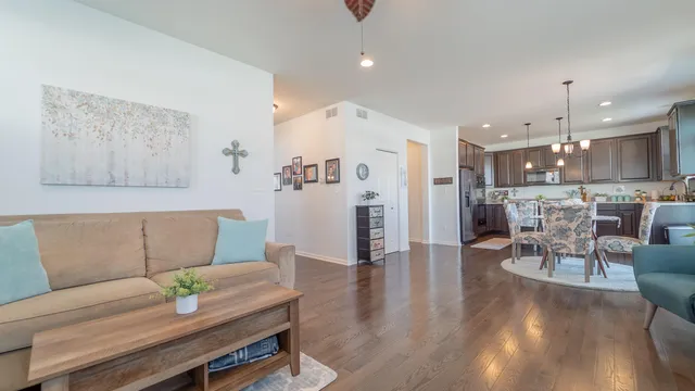 a living room with furniture and kitchen view