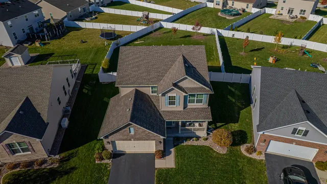 an aerial view of a house with a yard and garage