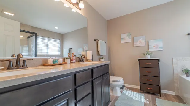 a bathroom with a sink a toilet and a mirror