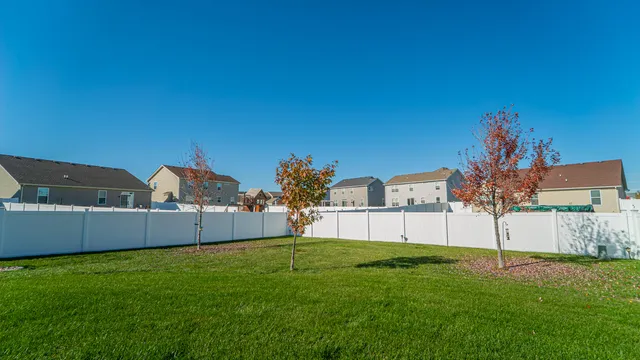a view of a backyard with table and chairs
