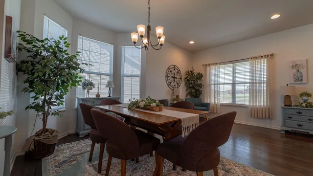 a view of a dining room with furniture and window
