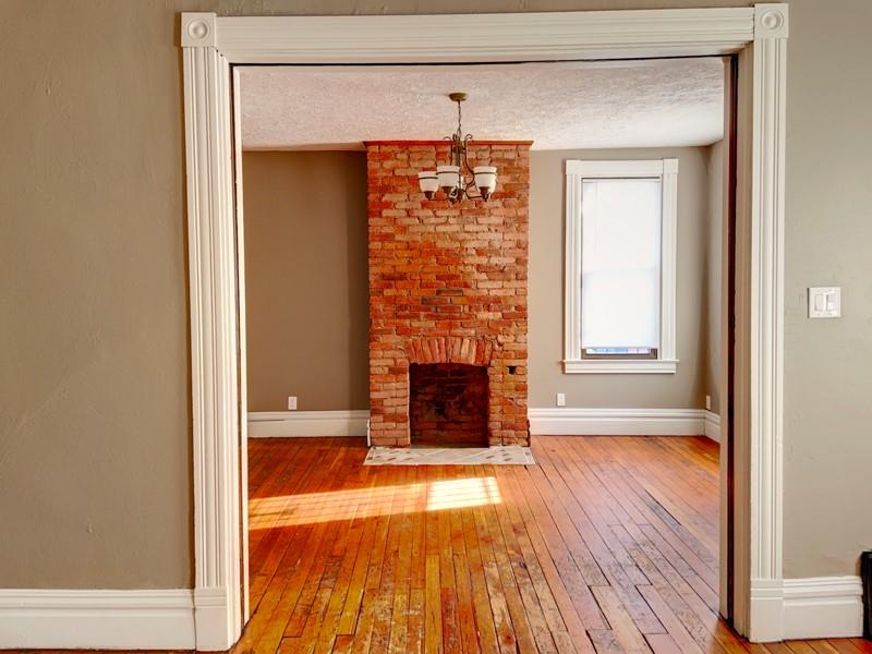 910 Page Street McKees Rocks, PA 15136 - Photo 5 of 25 view of a room with wooden floor and a fireplace