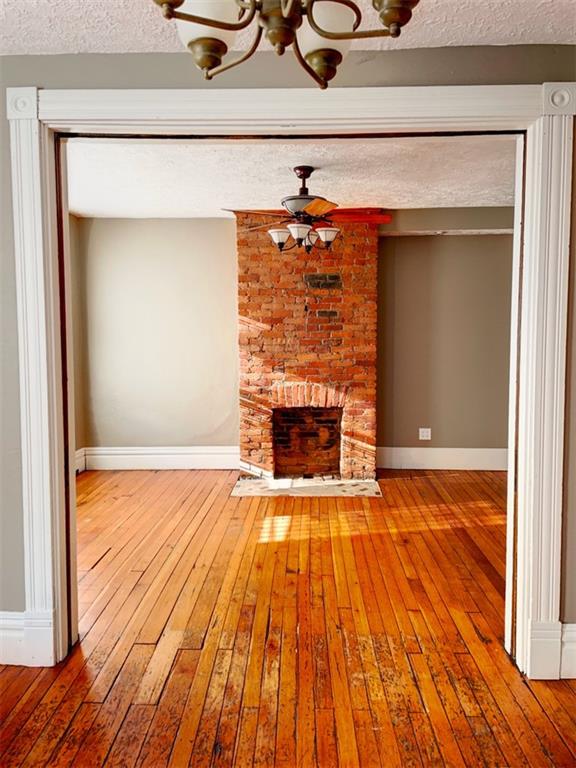910 Page Street McKees Rocks, PA 15136 - Photo 6 of 25 a view of empty room with wooden floor and fireplace