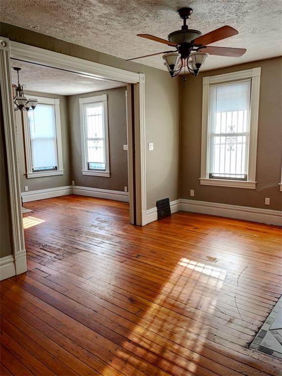 910 Page Street McKees Rocks, PA 15136 - Photo 8 of 25 a view of an empty room with window and wooden floor