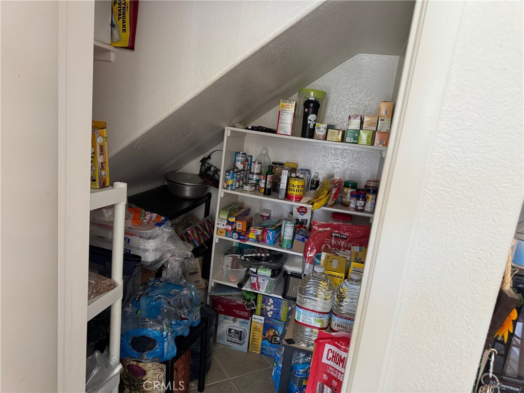 1338 Smoke Tree Lane Beaumont, CA 92223 - Photo 11 of 15 a room with lots of books and storage