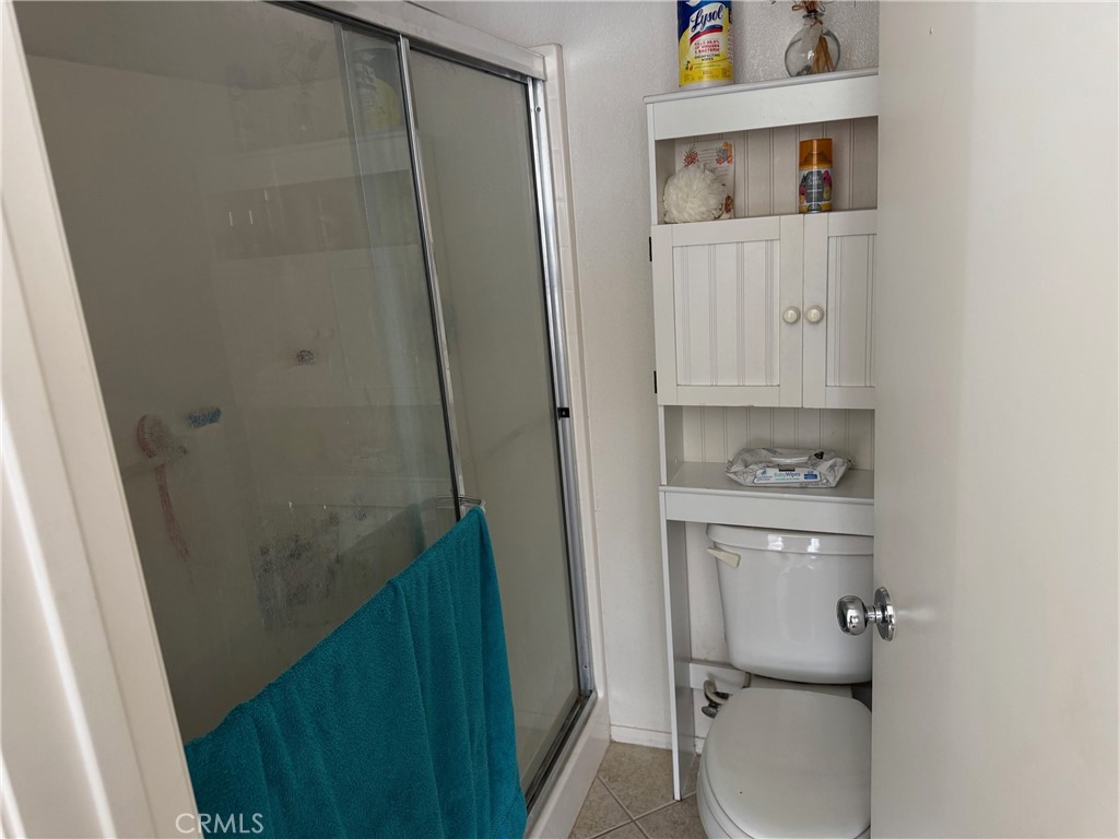 1338 Smoke Tree Lane Beaumont, CA 92223 - Photo 8 of 15 a bathroom with a shower toilet and sink