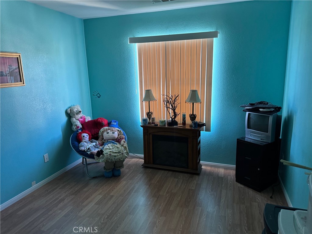 1338 Smoke Tree Lane Beaumont, CA 92223 - Photo 10 of 15 a room with wooden floor and furniture