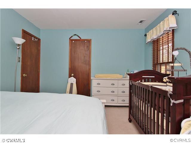 2919 Shiloh Church Road Midlothian, VA 23112 - Photo 12 of 24 a bedroom with a bed and wooden floor