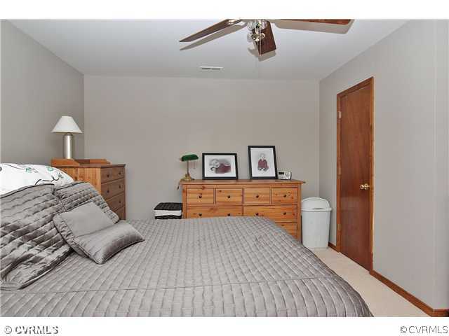 2919 Shiloh Church Road Midlothian, VA 23112 - Photo 18 of 24 a bedroom with a bed and wooden floor