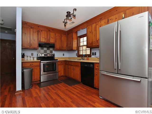 2919 Shiloh Church Road Midlothian, VA 23112 - Photo 9 of 24 a kitchen with stainless steel appliances granite countertop a refrigerator a sink dishwasher a stove with wooden cabinets