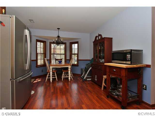 2919 Shiloh Church Road Midlothian, VA 23112 - Photo 10 of 24 a view of a dining room with furniture and wooden floor