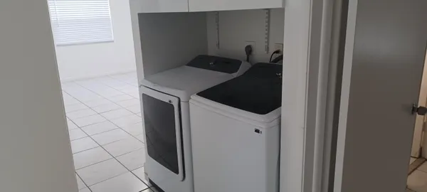 a utility room with washing machine
