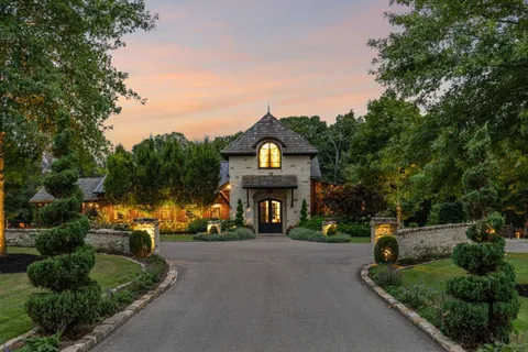 a front view of a house with a garden