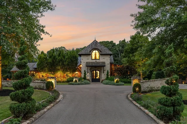 a front view of a house with a garden