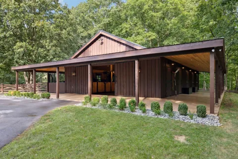 a house with lots of trees in the background