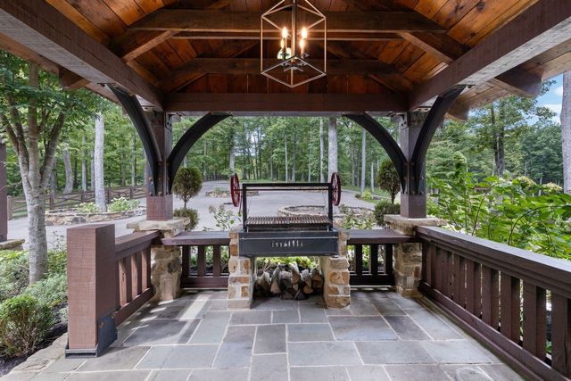 a outdoor space with patio the couches and pool table with chairs and potted plants