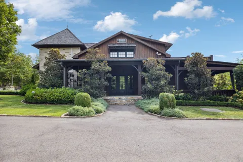 a living room with furniture a rug and a floor to ceiling window