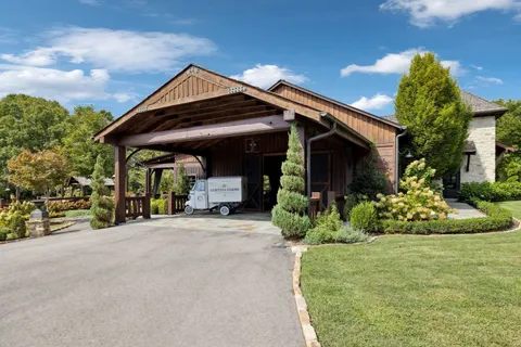 a outdoor space with furniture a large window and wooden floor