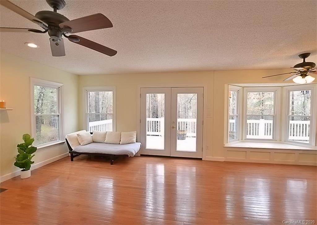 11068 Deep Cove Drive Tega Cay, SC 29708 - Photo 13 of 34 a living room with furniture and a large window