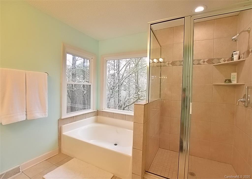 11068 Deep Cove Drive Tega Cay, SC 29708 - Photo 22 of 34 a bathroom with a bathtub and a shower