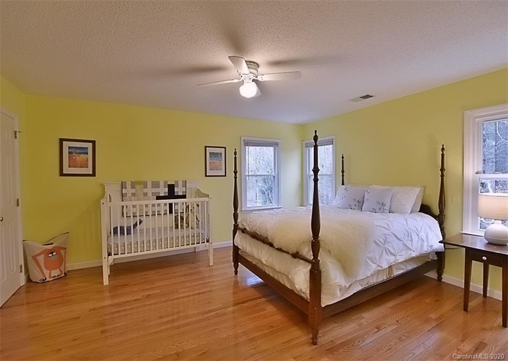11068 Deep Cove Drive Tega Cay, SC 29708 - Photo 23 of 34 a bed room with a bed and a chandelier
