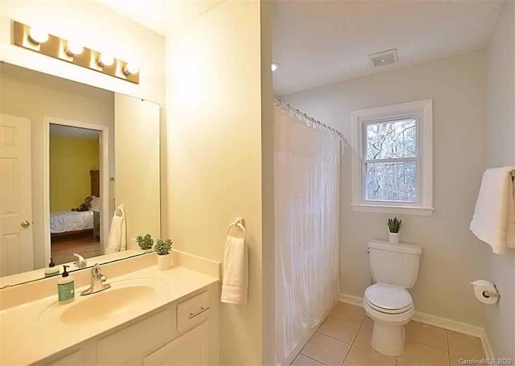 11068 Deep Cove Drive Tega Cay, SC 29708 - Photo 24 of 34 a bathroom with a sink a toilet and shower