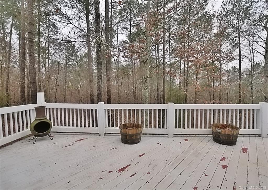 11068 Deep Cove Drive Tega Cay, SC 29708 - Photo 32 of 34 a view of a deck with a chair and wooden fence