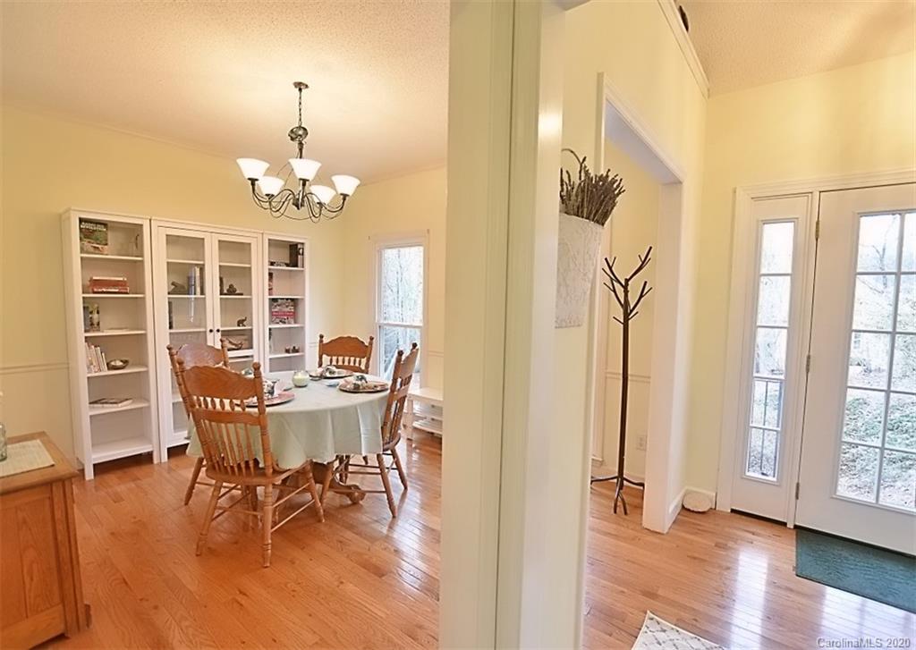 11068 Deep Cove Drive Tega Cay, SC 29708 - Photo 5 of 34 a view of a dining room with furniture wooden floor and chandelier