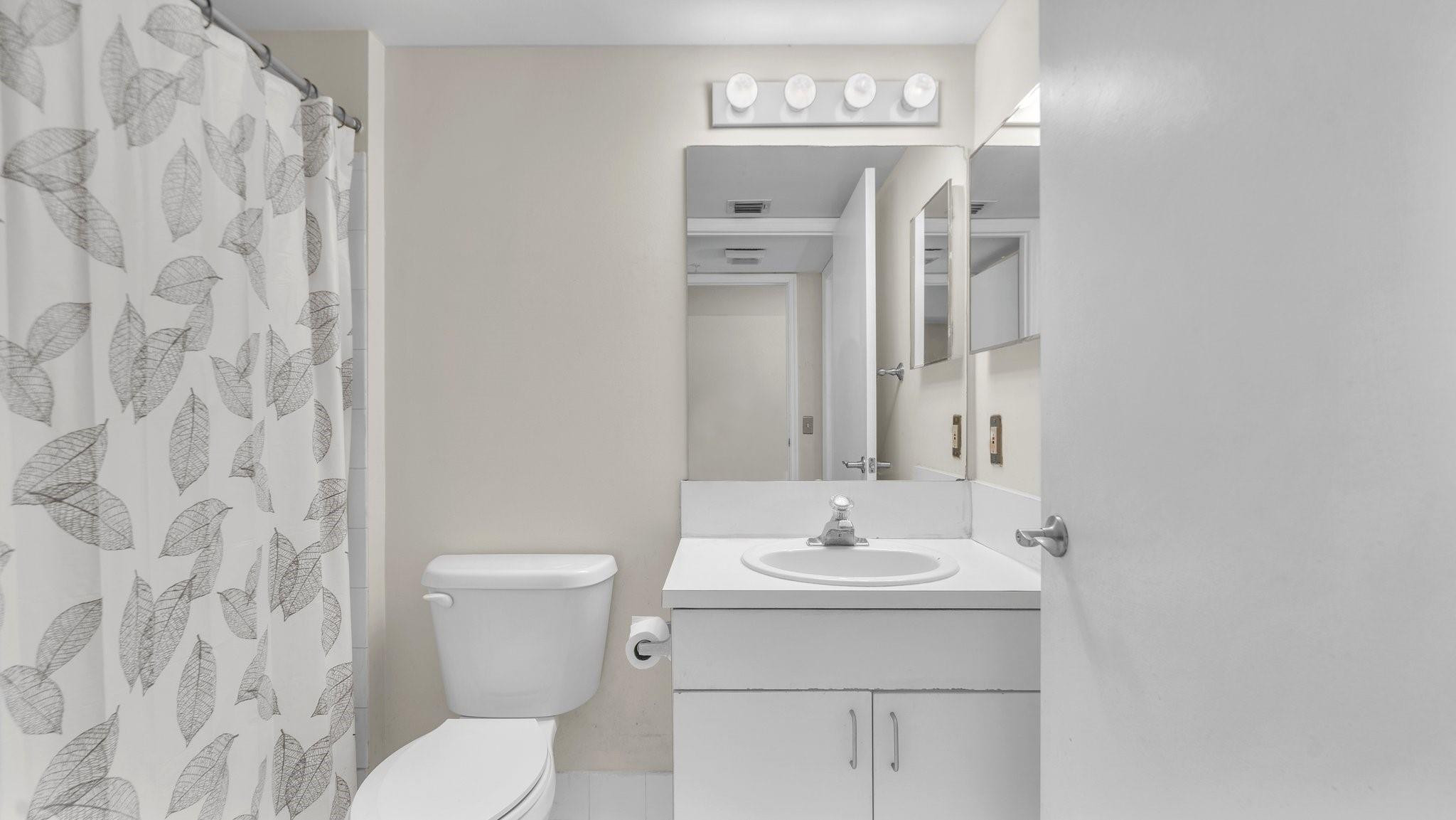 430 South Park Road, Unit 3303 Hollywood, FL 33021 - Photo 12 of 27 a bathroom with a sink a toilet and a mirror