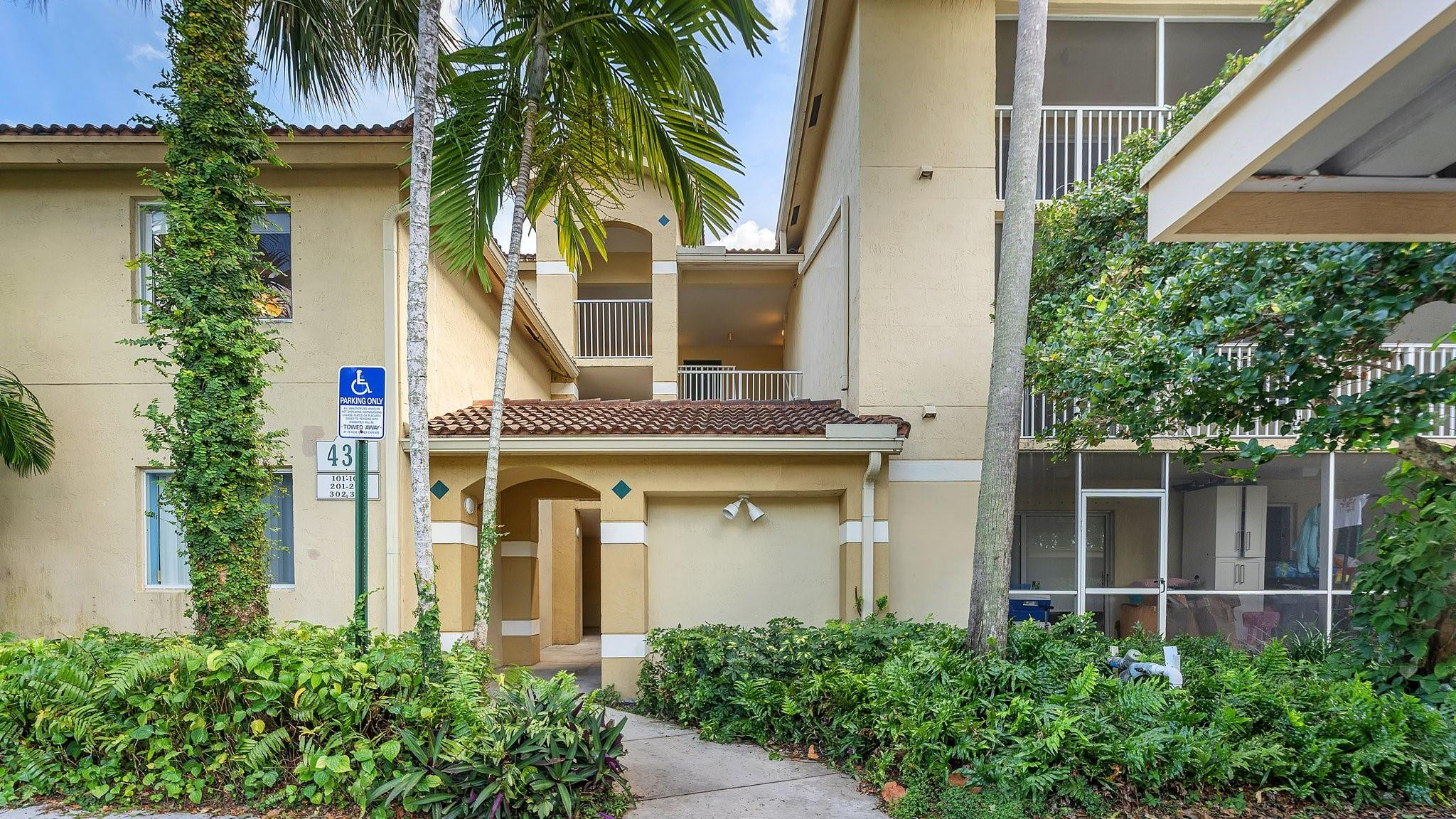 430 South Park Road, Unit 3303 Hollywood, FL 33021 - Photo 2 of 27 a front view of a house with glass windows and a yard