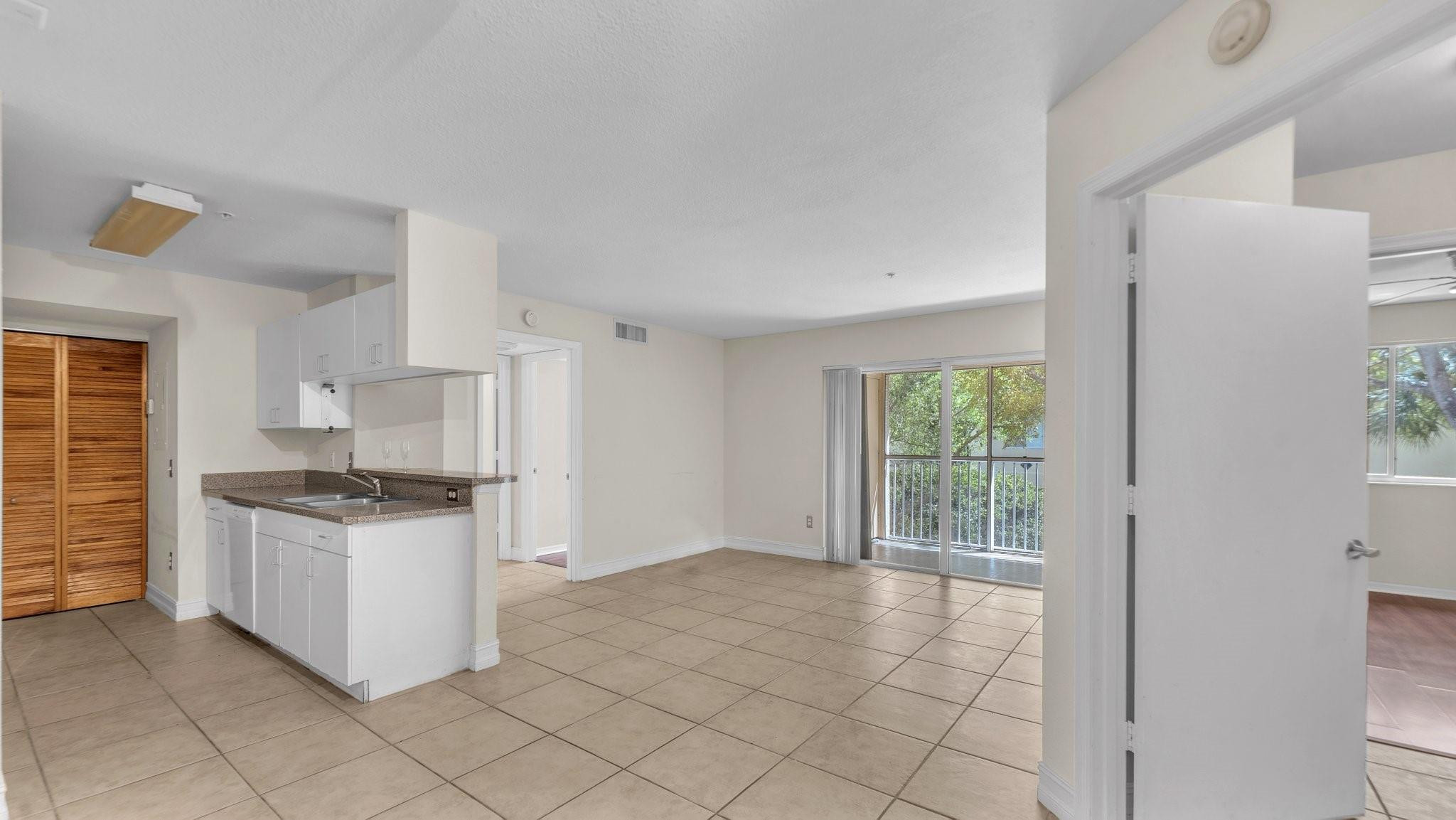 430 South Park Road, Unit 3303 Hollywood, FL 33021 - Photo 5 of 27 a kitchen with granite countertop a stove top oven and cabinets